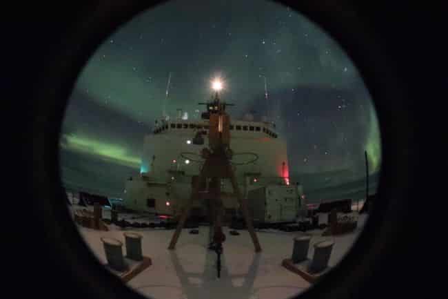 Coast Guard Cutter Healy conducts their Arctic West Summer 2018 science mission with the northern lights visible above the ship while in the Arctic Ocean