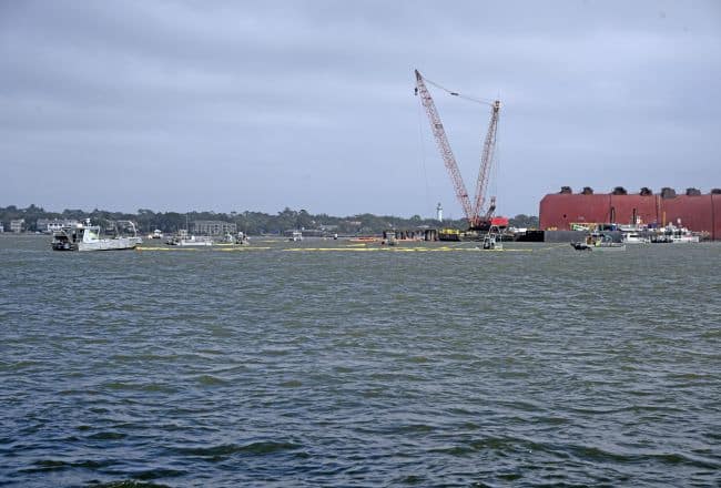 Responders maneuver boom in formations designed to mitigate any pollution threats