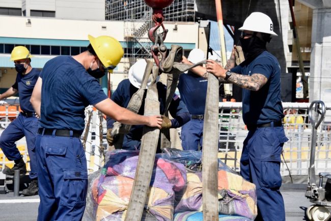 The Coast Guard Cutter Hamilton (WMSL 753) crew members offload approximately 11,500 pounds of cocaine and approximately 17,000 pounds of marijuana,